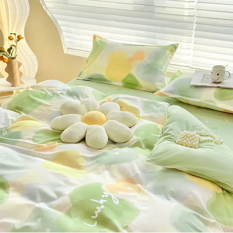 A plush white and yellow flower-shaped pillow on the bed from decorbites aloe cotton printed bedding set