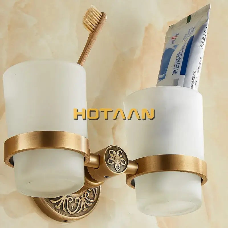 Antique brass-finished aluminium double tumbler holder with frosted glass cups and ornate floral detailing for bathroom use