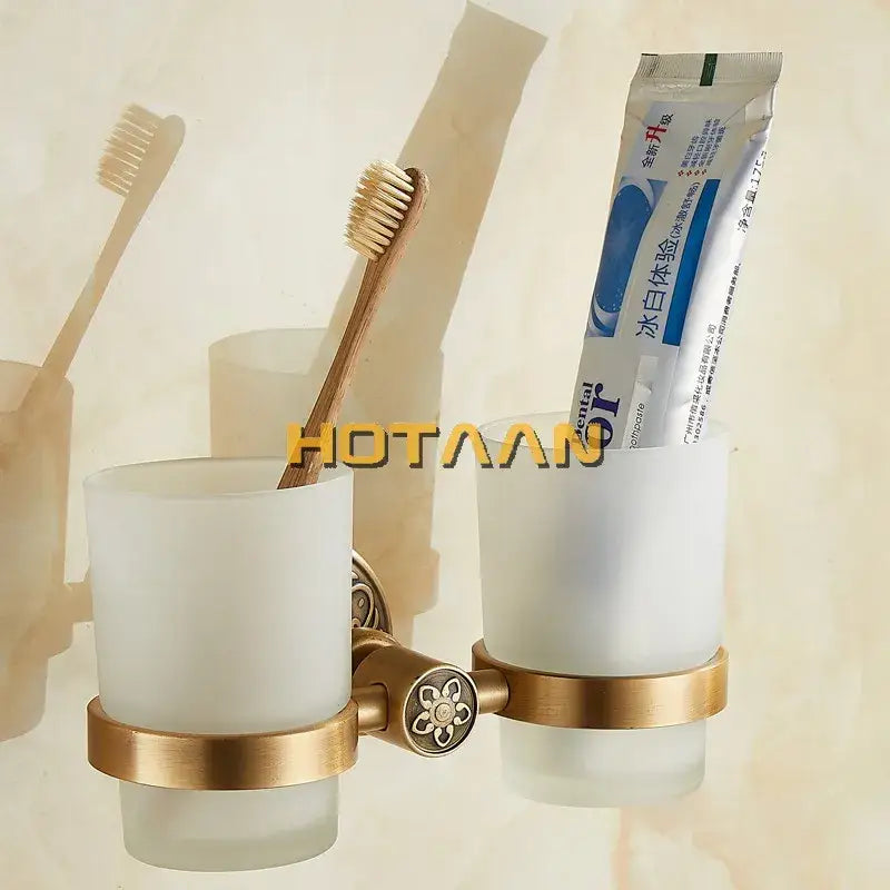 Brass-finished aluminium double tumbler holder with frosted white glass cups for bathroom accessories by DecorBites