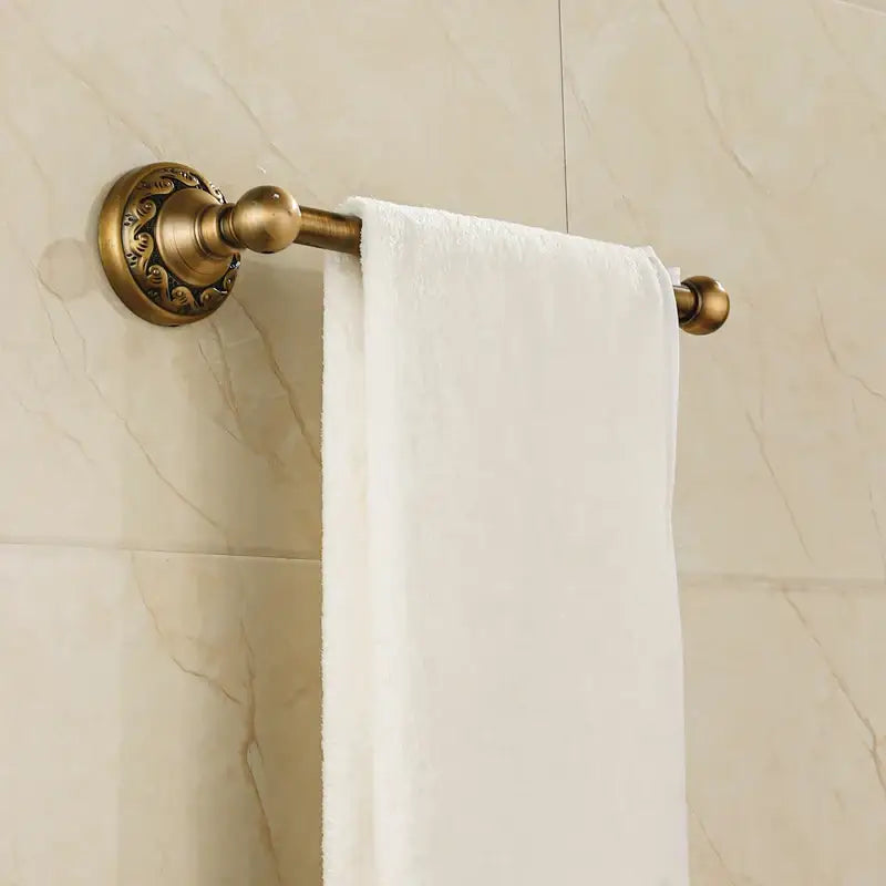 Decorbites aluminium wall mounted round towel holder in antique brass with ornate floral detailing and spherical finials