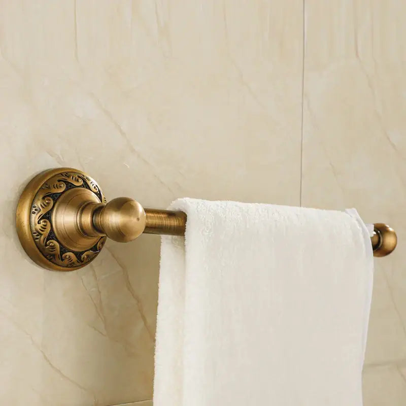 DecorBites aluminium wall mounted towel holder in antique brass with ornate floral detailing and polished finish