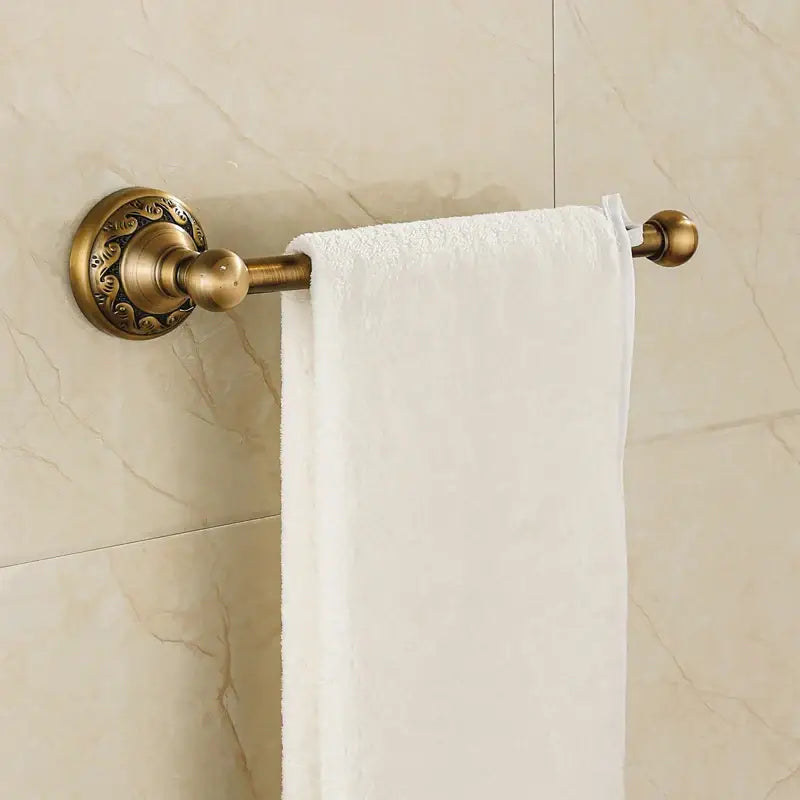 DecorBites™ aluminium wall mounted round towel holder in antique brass with ornate floral detailing and white towel