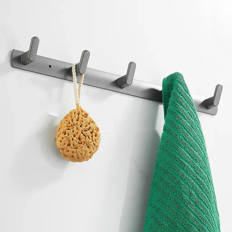 Gray aluminum alloy towel hooks wall mounted rack with four hooks holding a yellow loofah and green towel