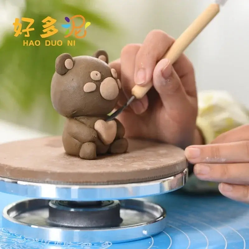 Brown clay bear figurine with beige features sculpted on a pottery wheel using decorbites aluminum alloy turntable
