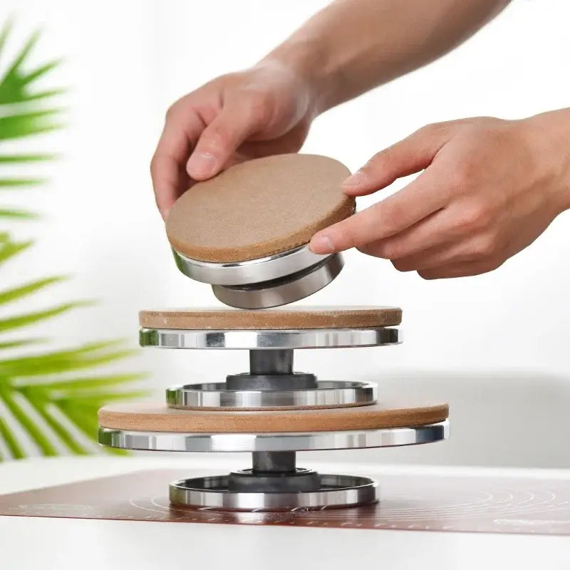 Stacked circular aluminum alloy turntable with wooden tops and metallic bases for clay sculpture rotation