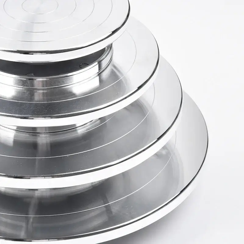Stacked circular aluminum alloy turntables with shiny silver finish and concentric grooves for pottery wheel rotation