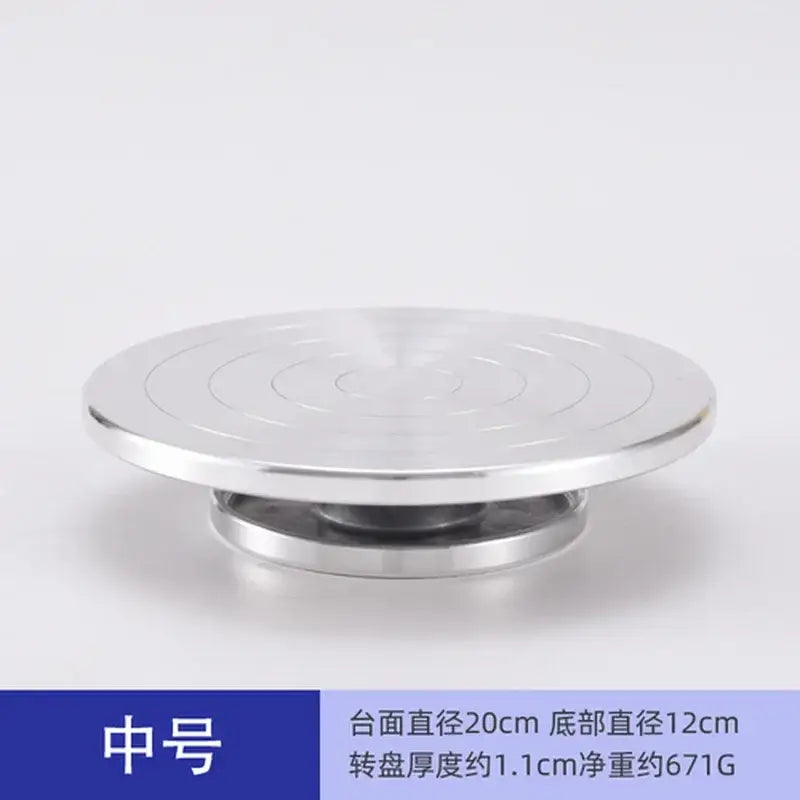 Silver metallic aluminum alloy turntable with concentric circular grooves for clay sculpture and pottery wheel rotation