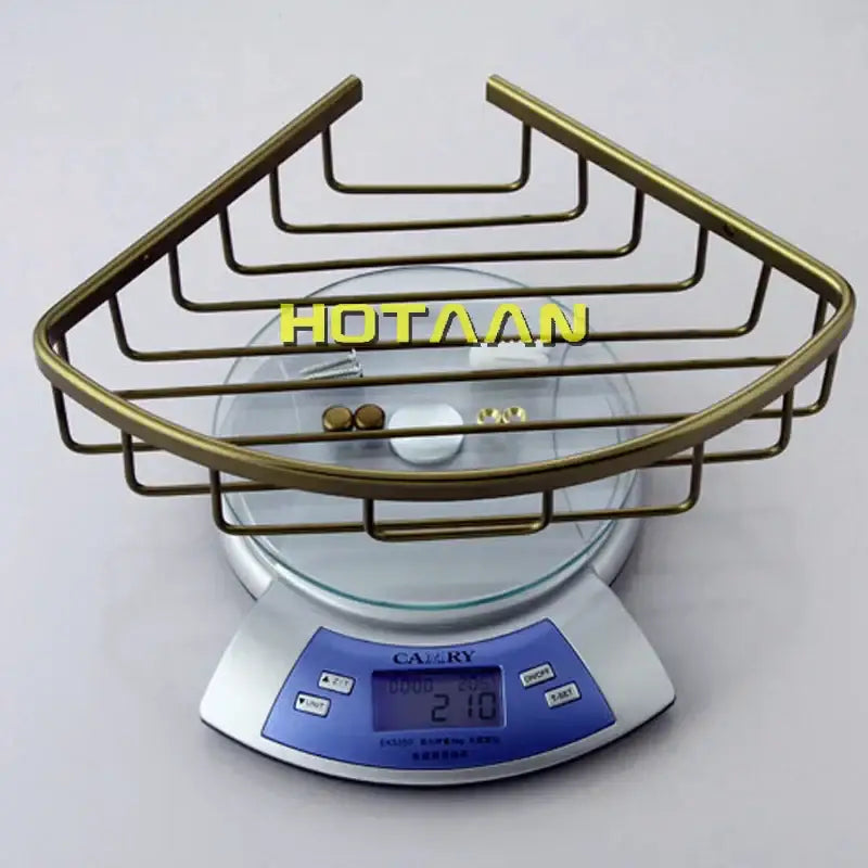 Brass-colored aluminum shower basket holder with triangular wireframe design single layer basket holder shelf