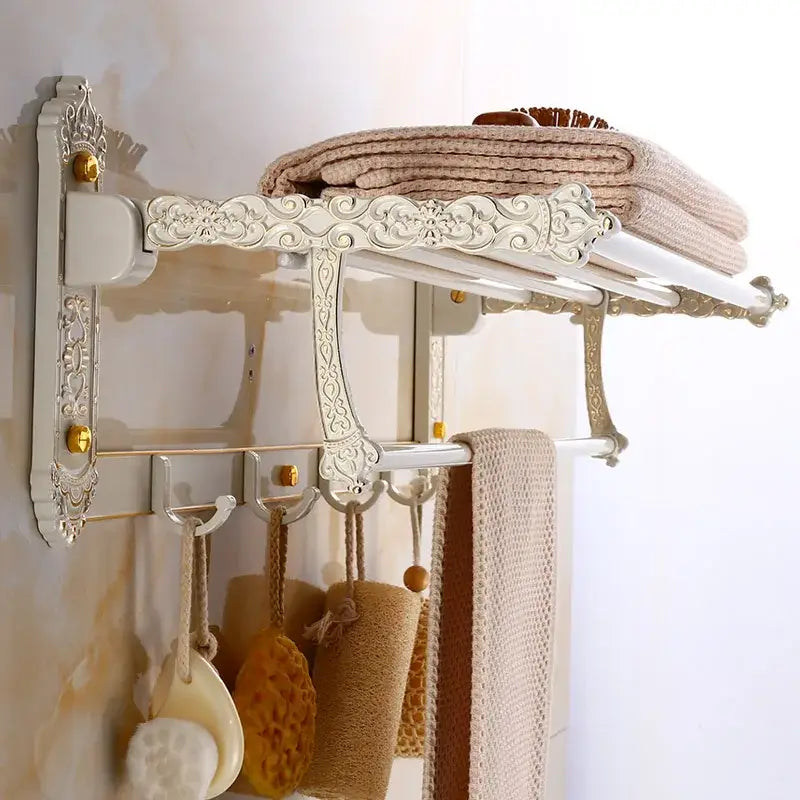 Antique white and gold aluminum bath hardware set with ornate scrollwork shelf and towel rack by decorbites