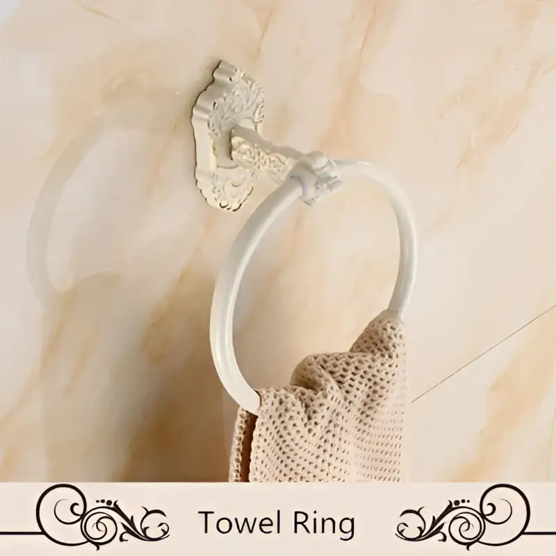 White ornate aluminum towel ring with vintage-style wall mount from DecorBites bath hardware set for bathroom use