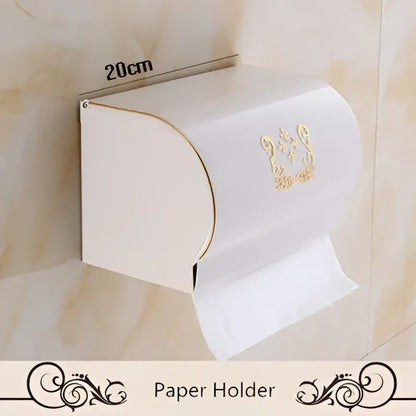 White wall-mounted aluminum paper holder with gold ornate detailing from decorbites bath hardware set