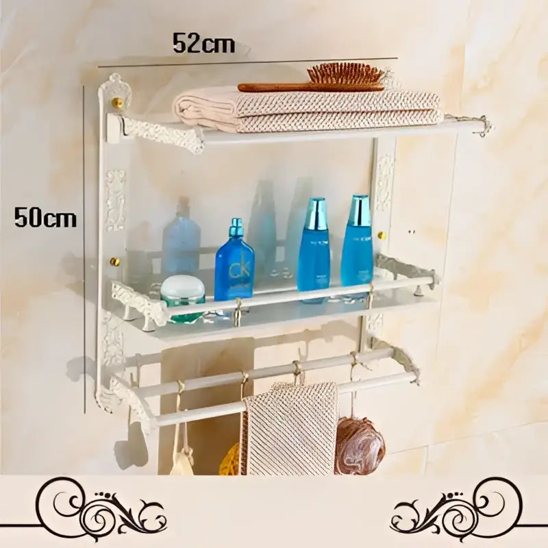 Clear glass shelf with ornate white aluminum frame holding toiletries in decorbites bath hardware set