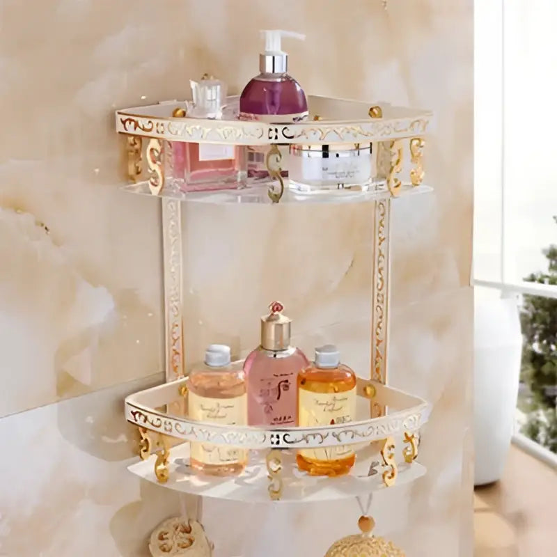 Clear glass bathroom corner shelf with ornate gold trim and decorative scrollwork by decorbites aluminum basket