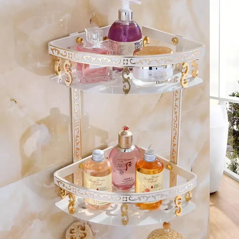 White and gold ornate aluminum bathroom corner shelf with glass shelves holding toiletries in antique finish