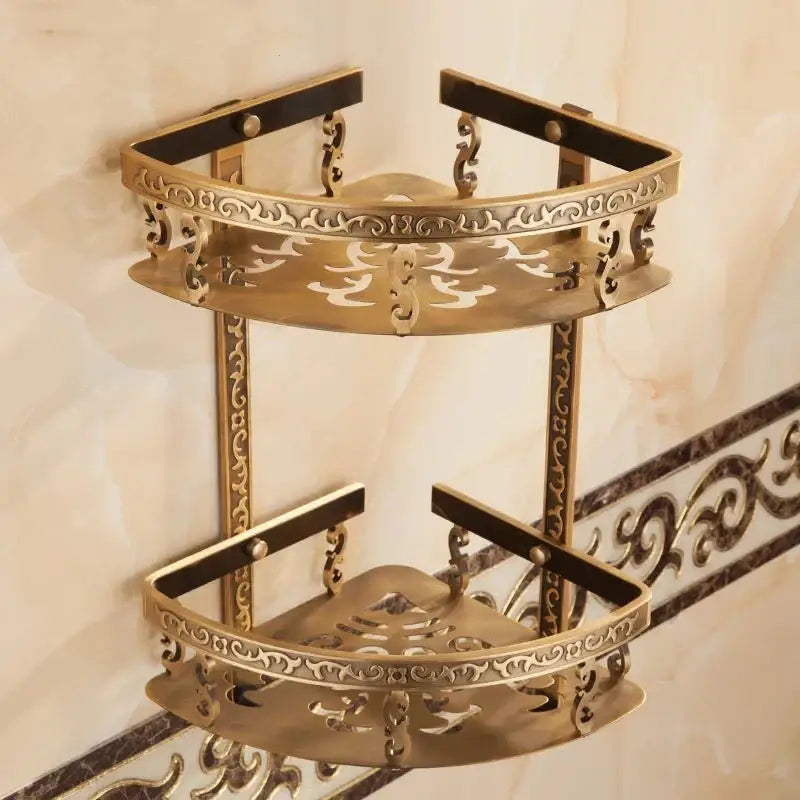 Brass double-tier corner shelf with ornate scrollwork and black trim ideal as a bathroom corner shelf for shower rooms