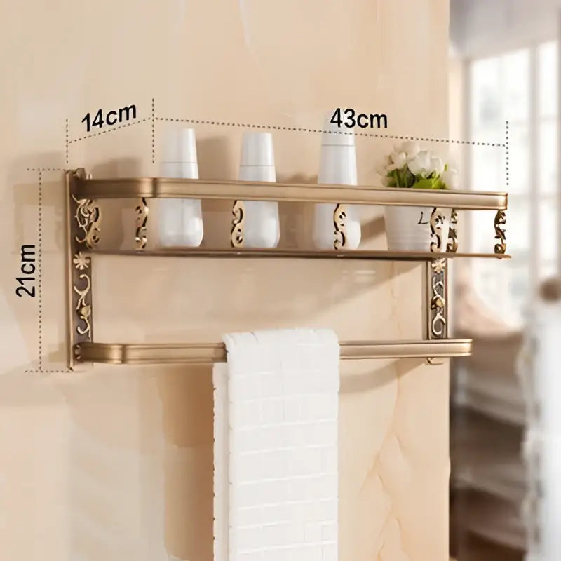 Brass-finished decorbites aluminum bathroom corner shelf with ornate scrollwork towel rack holding three white cups