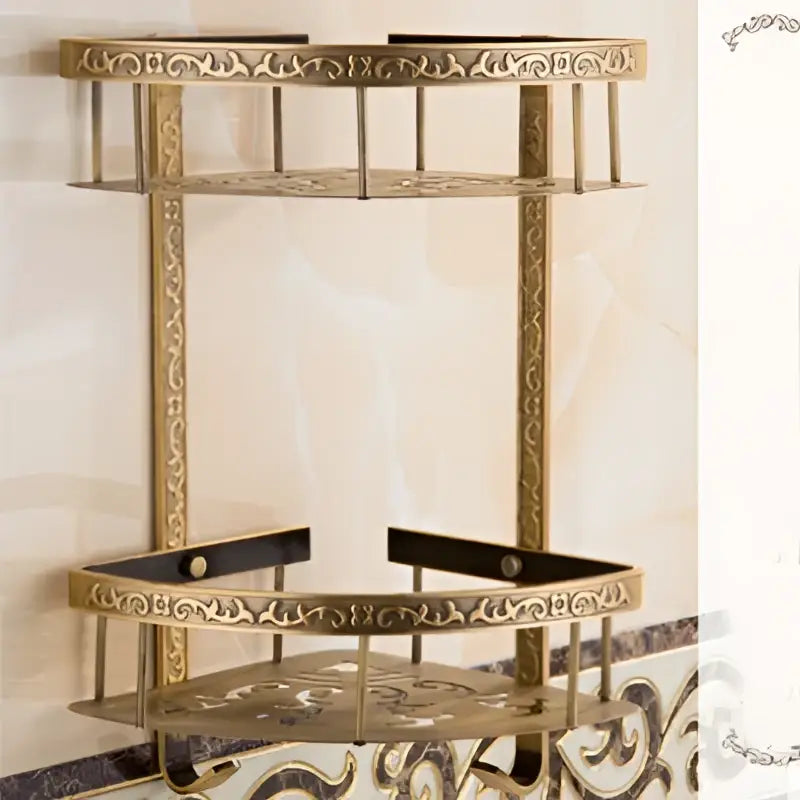 Gold-toned ornate two-tier aluminum bathroom corner shelf with intricate scrollwork and antique finish for shower room use