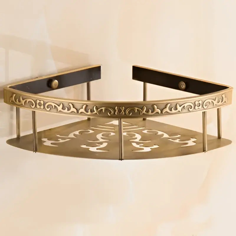 Brass-finished aluminum bathroom corner shelf with ornate scrollwork and floral cut-out patterns for shower room storage