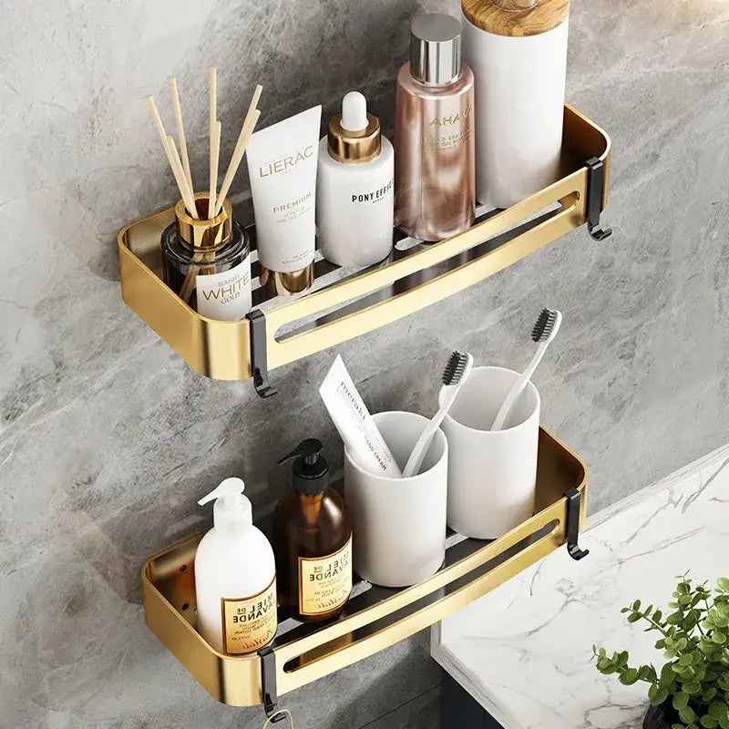Gold-colored aluminum bathroom corner shelf with double tiers and black mounting brackets for wall mounted storage