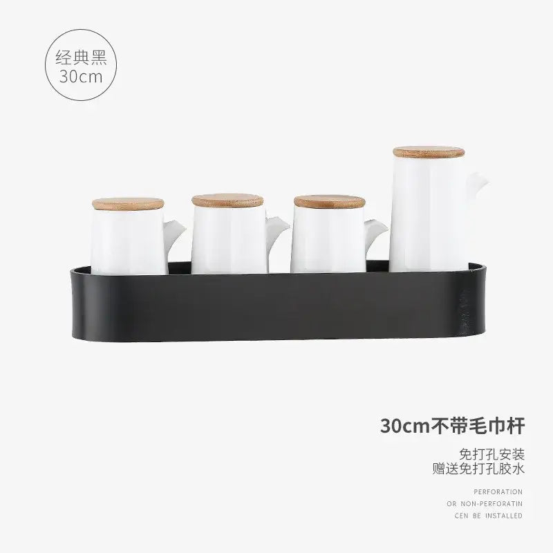 Black metal wall-mounted spice rack with four white ceramic jars complements decorbites aluminum bathroom shelf with towel bar