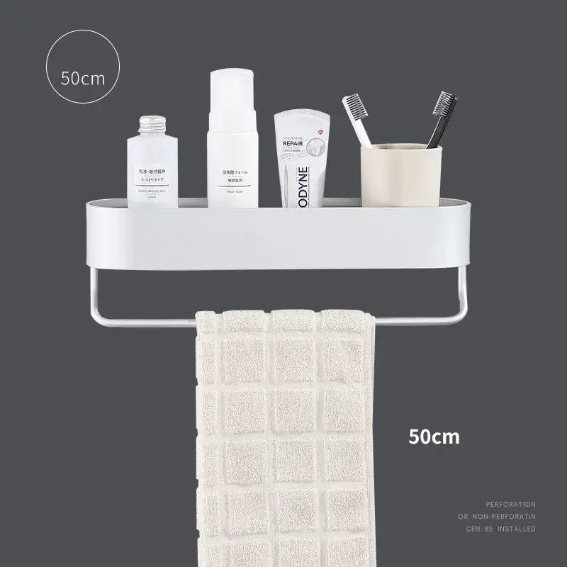 White plastic bathroom shelf with integrated towel bar holding toiletries and beige towel for bath organization