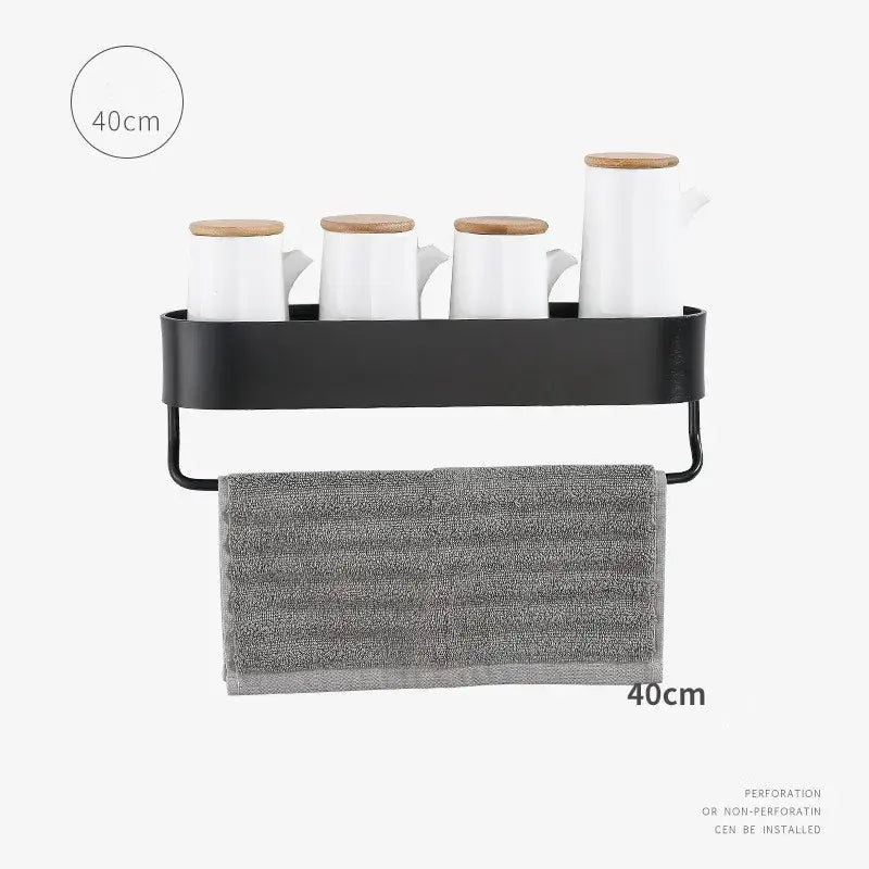 Decorbites aluminum bathroom shelf in black metal with towel bar holding white ceramic mugs and gray textured towel