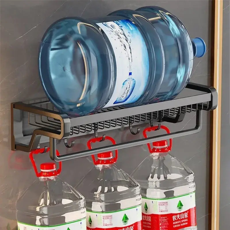 Black metal aluminum bathroom towel holder with storage basket and hooks holding large blue and clear water bottles