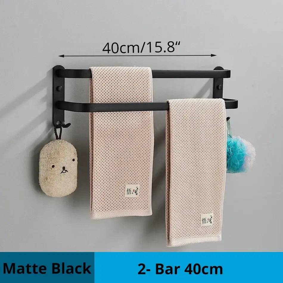 Matte black decorbites aluminum bathroom towel rack wall mounted with double bars holding two beige towels