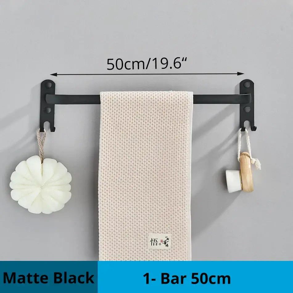 Matte black decorbites aluminum bathroom towel rack with hook holding a beige textured towel wall mounted design