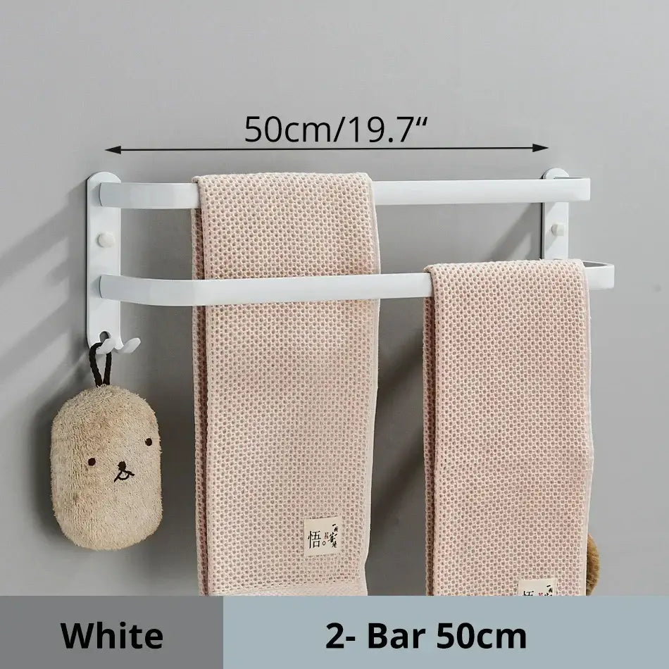 White aluminum bathroom towel rack wall mounted with double bars holding two beige textured towels by decorbites