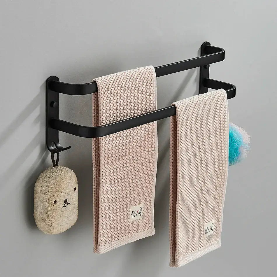 DecorBites aluminum bathroom towel rack with double-tier black wall-mounted design and beige textured towels hanging