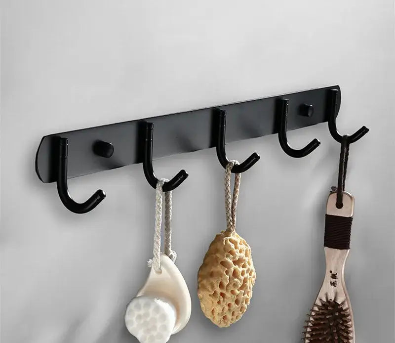 Black metal wall-mounted hook rack with five curved hooks in the decorbites aluminum black bathroom hardware set