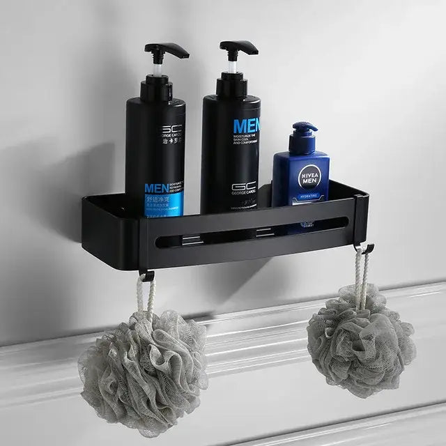Black aluminum wall-mounted shower caddy holding bottles and loofahs in decorbites bathroom hardware set