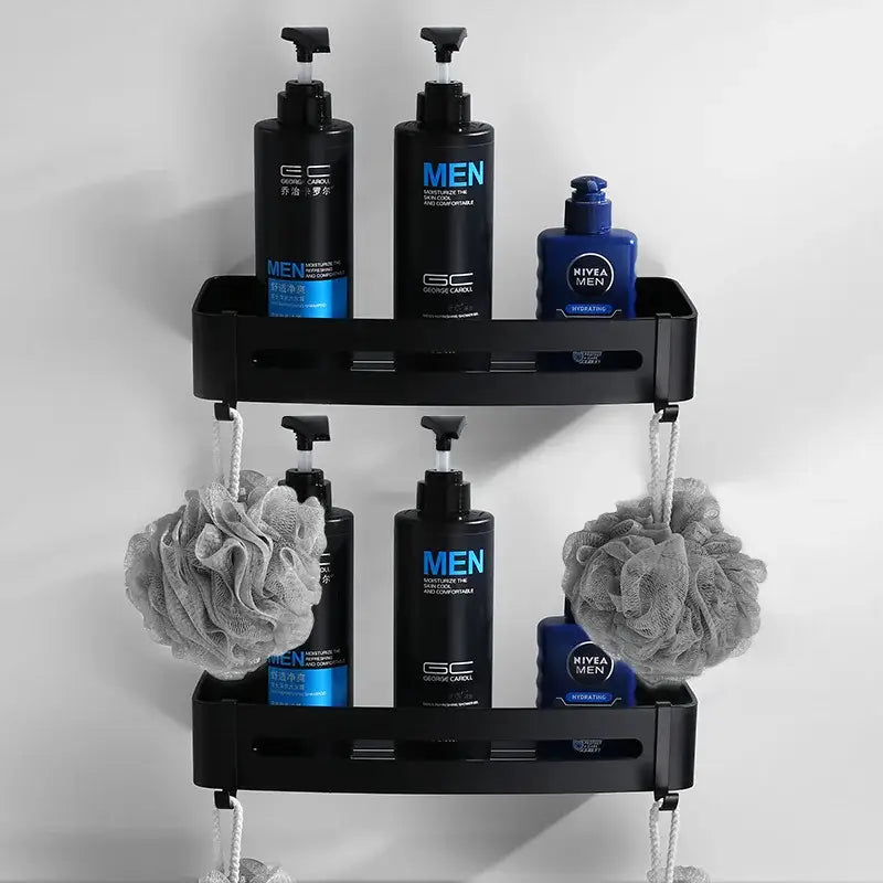 Black two-tier aluminum shower caddy holding toiletries and gray loofahs from decorbites bathroom hardware set
