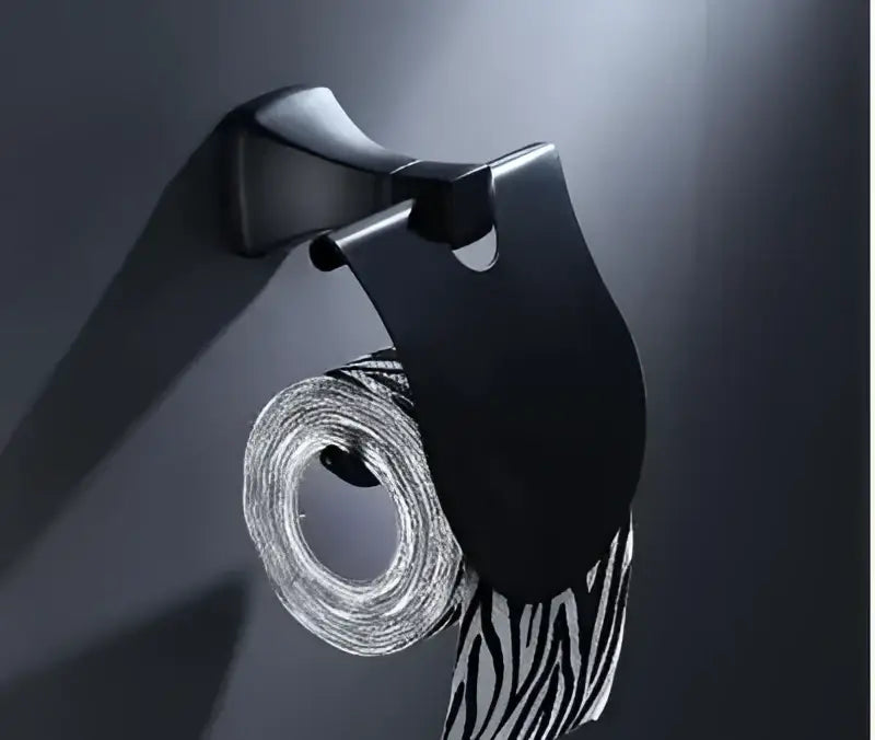 Black metallic aluminum toilet paper holder with zebra-striped roll from DecorBites bathroom hardware set
