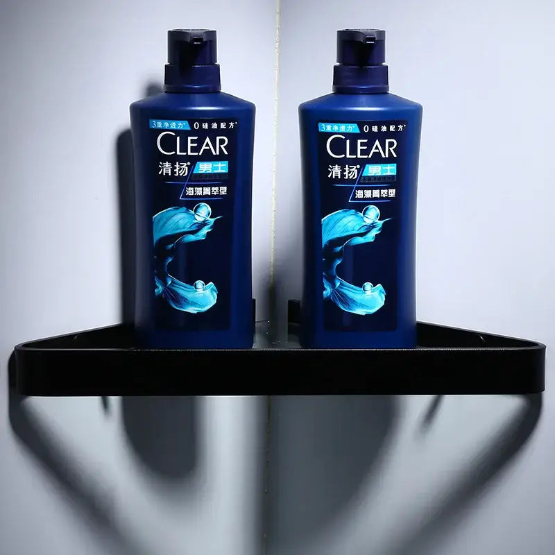 Two dark blue plastic bottles of clear men’s shampoo with glossy finish shown alongside decorbites™ aluminum black bathroom hardware set