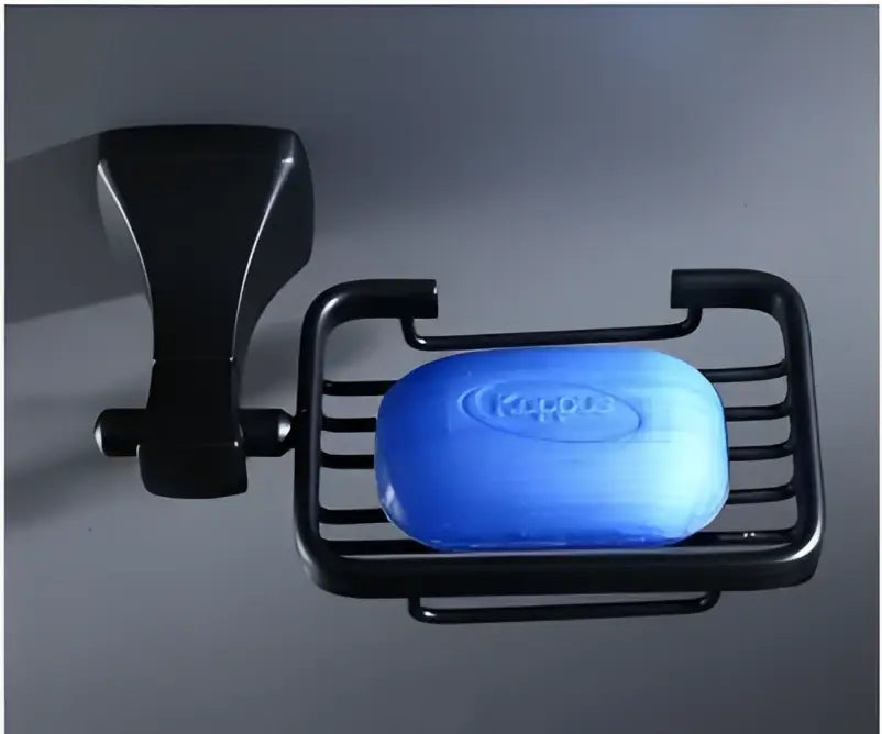 Black metal soap dish in the decorbites™ aluminum black bathroom hardware set holding blue kappas soap bar