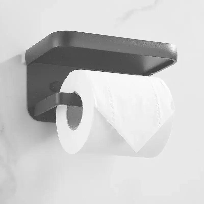 Black matte aluminum DecorBites™ tissue holder with phone shelf holding white toilet paper roll in modern design