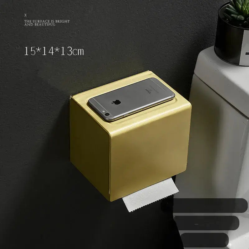 Gold-colored metallic aluminum tissue box with sleek minimalist design and rounded edges for toilet paper holder use