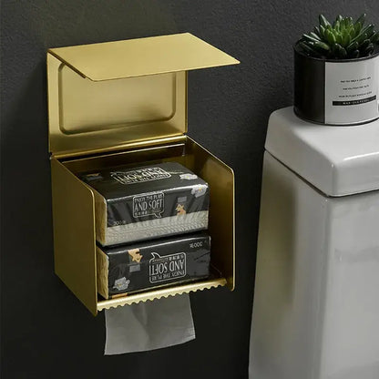 Gold-colored aluminum tissue box holder with hinged lid and scalloped edge for bathroom toilet paper storage