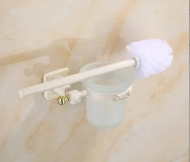 Decorbites aluminum carved toilet brush holder set with white toilet brush frosted glass holder and gold-toned accents mounted on wall