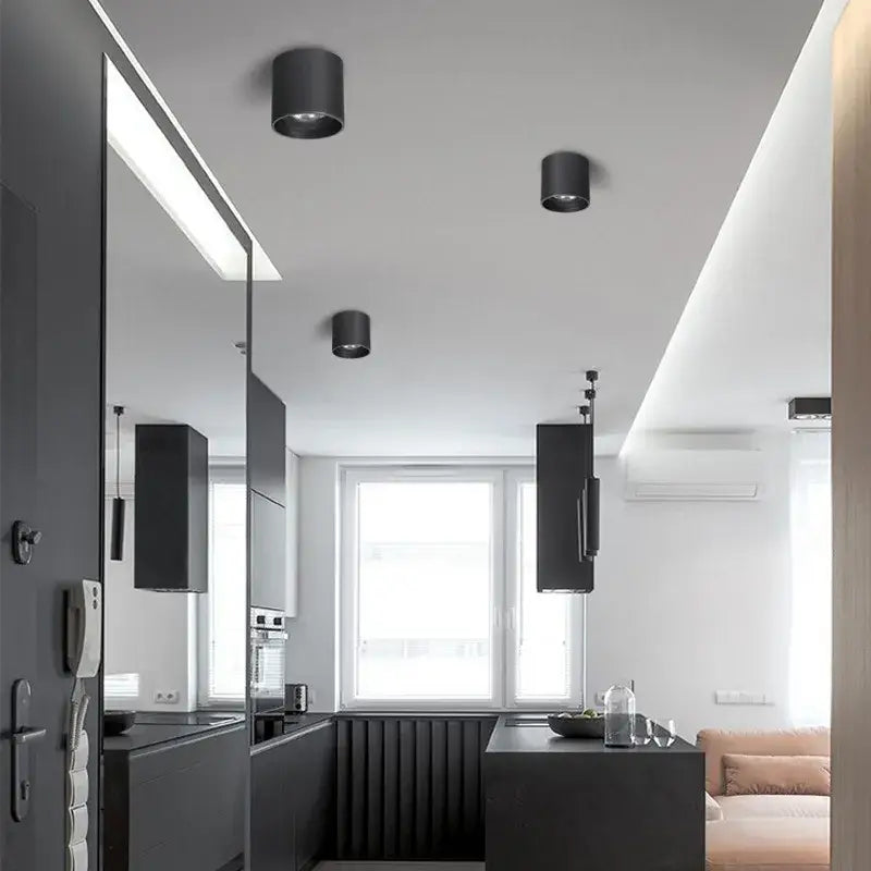 Three sleek black aluminum ceiling lamps by DecorBites with a matte finish and adjustable beam angle downlight