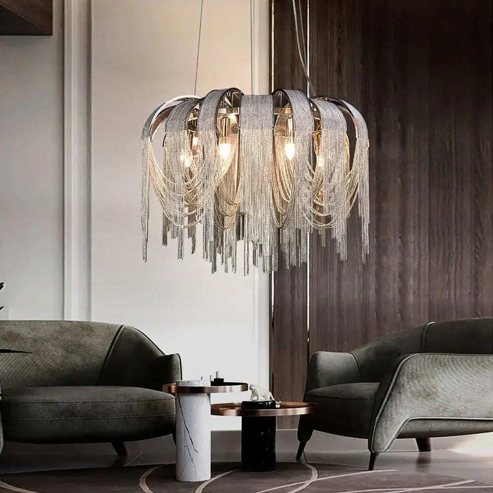 DecorBites aluminum chain pendant lights with cascading silver chains and warm lighting above a dining table