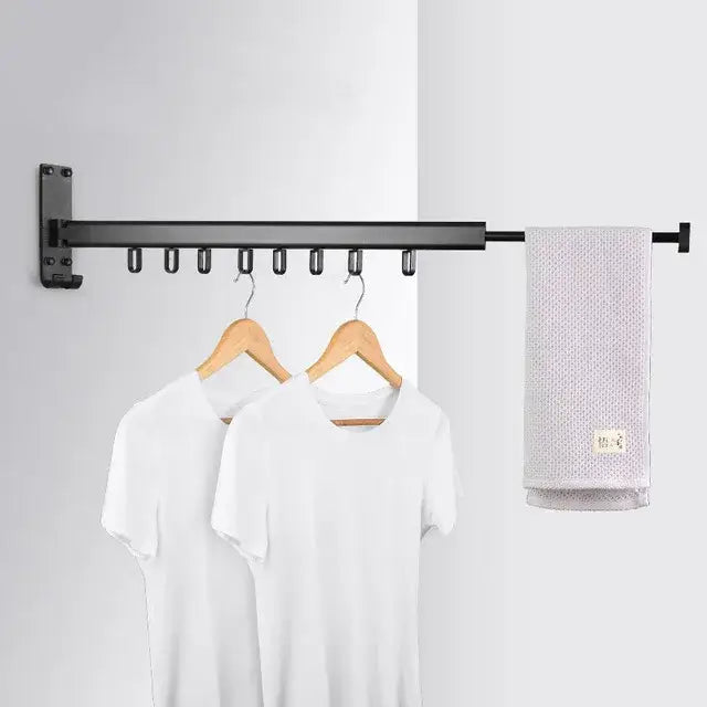 Black aluminum clothing hanger organizer rack with multiple hooks holding wooden hangers and gray towel