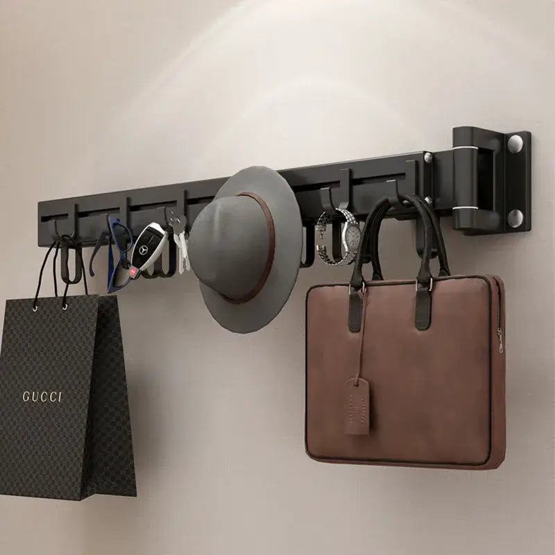 Black aluminum clothing hanger organizer rack by DecorBites with multiple hooks holding hat keys watch and handbag