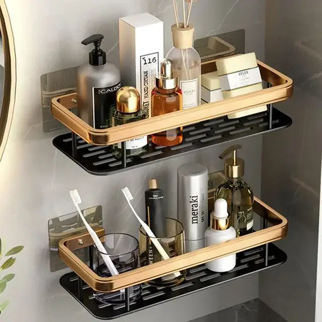 Gold-framed black slatted two-tier aluminum corner bathroom shelf with towel holder from DecorBites