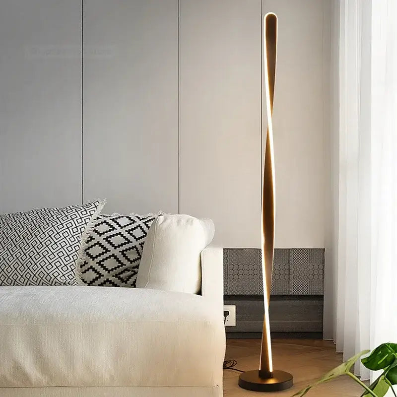 A sleek twisted gold-finished aluminum floor lamp with modern design and dimmable led lighting by decorbites