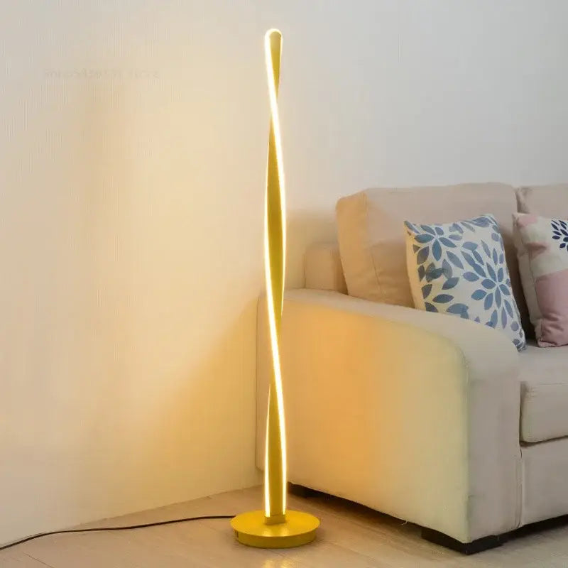 Golden twisted aluminum floor lamp with sleek modern design and warm dimmable led lighting by decorbites