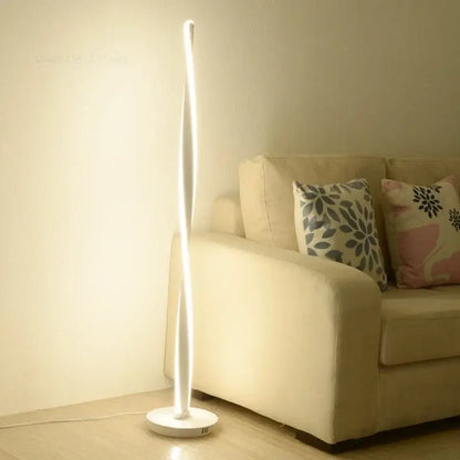 DecorBites™ aluminum floor lamp with sleek white LED lights and curved design on a circular base for modern decor