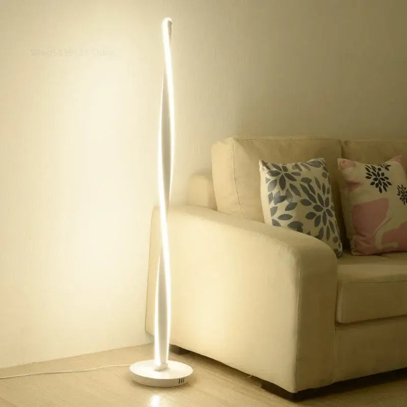 DecorBites™ aluminum floor lamp with sleek white LED lights and curved design on a circular base for modern decor